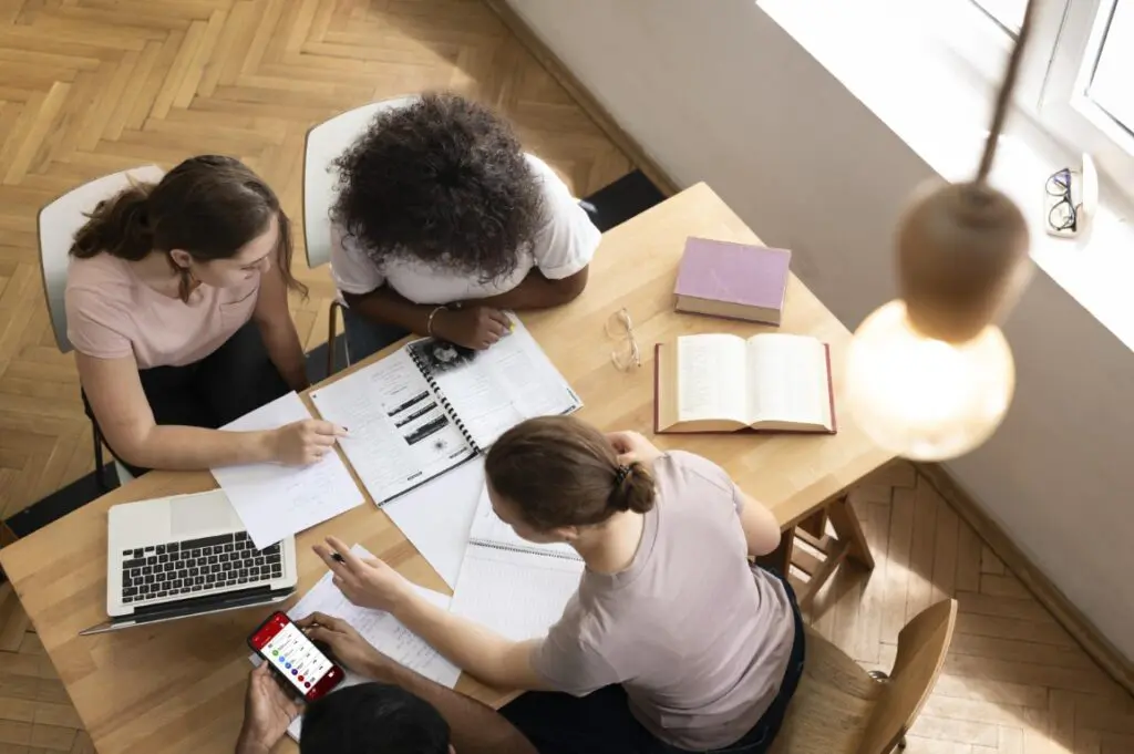 Group of adults reviewing a plan during a career and academic counseling session.